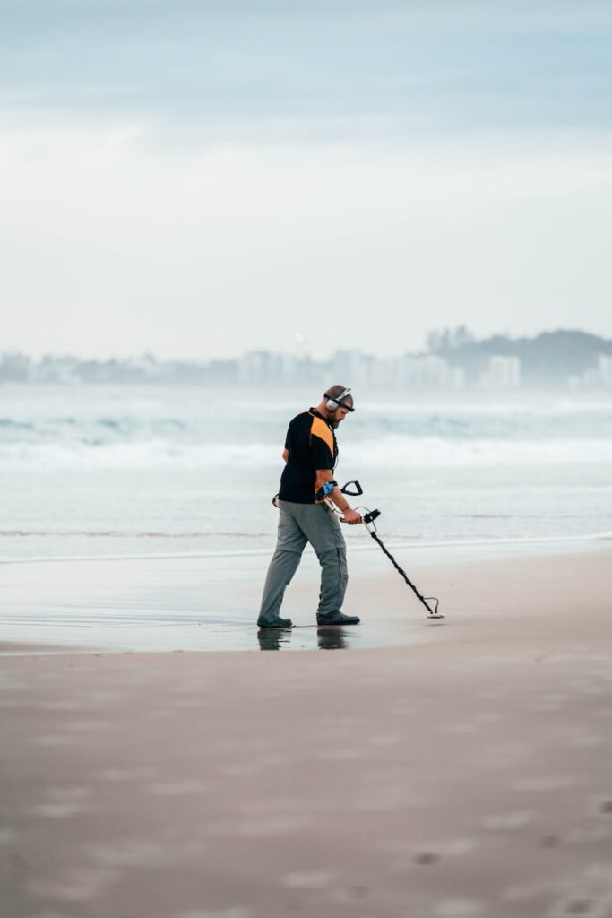 a man walking on the beach with a fishing pole