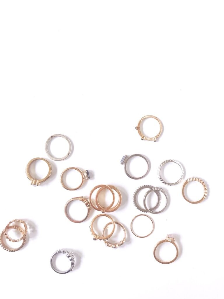 silver and gold rings on white surface